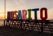 Playas de Rosarito mantiene sólida actividad turística durante el Memorial Day Weekend 2026* Playas de Rosarito, Baja California; martes 26 de mayo de 2026. El Gobierno Municipal de Playas de Rosarito, encabezado por la Presidenta Municipal, Rocío Adame Muñoz, a través de la Secretaría de Desarrollo Económico y Turismo (SEDETUR), destacó los resultados positivos registrados durante el Memorial Day Weekend 2026, uno de los periodos turísticos más importantes para el destino debido a la afluencia de visitantes provenientes principalmente del sur de California. De acuerdo con datos preliminares compartidos por la Asociación de Hoteles y Moteles de Playas de Rosarito y contrastados con mediciones internas realizadas por el Comité de Turismo y Convenciones de Playas de Rosarito, durante el fin de semana se registró el siguiente comportamiento en la muestra hotelera del destino: Ocupación Hotelera Memorial Day Weekend 2026 • Viernes: 61% • Sábado: 100% • Domingo: 79% En comparación con el mismo periodo de 2025: Ocupación Hotelera Memorial Day Weekend 2025 • Viernes: 72% • Sábado: 98% • Domingo: 80% Considerando el promedio general de los tres días del fin de semana: • Memorial Day Weekend 2026: 80% • Memorial Day Weekend 2025: 84% Con base en indicadores de ocupación hotelera, movilidad vehicular y comportamiento turístico observado durante el Memorial Day Weekend 2026, se estima una afluencia superior a los 20 mil visitantes en Playas de Rosarito, entre turistas hospedados, excursionistas y visitantes de un solo día. Asimismo, considerando el gasto promedio diario por visitante establecido en el más reciente Perfil del Turista de Rosarito del Observatorio Turístico de Baja California, se estima un consumo turístico superior a los 24 millones de pesos en el municipio durante el fin de semana festivo. Esta estimación contempla el comportamiento de turistas hospedados, excursionistas y visitantes de un solo día, así como el gasto realizado en hospedaje, alimentos y bebidas, entretenimiento, comercio, recreación, transporte y otros servicios vinculados a la actividad turística. En materia gastronómica, la CANIRAC Rosarito reportó un flujo positivo en restaurantes, registrando establecimientos con niveles de afluencia entre buena y mucha actividad, manteniendo un balance general bastante positivo durante el fin de semana festivo. Aunado a ello, datos de movilidad vehicular de CAPUFE y FIARUM reflejan el importante flujo turístico registrado en la región durante los días 22, 23 y 24 de mayo. Tan solo en la plaza de cobro de Rosarito se contabilizó el tránsito de 65 mil 955 vehículos, mientras que en el Nodo Popotla se registraron 11 mil 322 cruces vehiculares, evidenciando una alta movilidad turística y recreativa en el municipio durante el fin de semana largo. El Secretario de Desarrollo Económico y Turismo, Lic. Irán Leonardo Verdugo, señaló que estos resultados reflejan no solamente la fortaleza turística del destino, sino también la confianza que visitantes nacionales y extranjeros continúan depositando en Playas de Rosarito como uno de los principales destinos de playa del noroeste del país. Asimismo, destacó que el trabajo coordinado entre el Gobierno Municipal, organismos turísticos, cámaras empresariales y la iniciativa privada ha permitido fortalecer la promoción, competitividad y oferta turística del municipio, generando beneficios directos para sectores como hotelería, gastronomía, comercio, recreación y servicios turísticos. Verdugo señaló además que el Memorial Day Weekend representa uno de los principales indicadores o “termómetros” para medir el comportamiento esperado de la temporada de verano en Playas de Rosarito, por lo que los resultados registrados durante este periodo reflejan un panorama favorable para los próximos meses en materia de actividad turística, movilidad y consumo en el destino. Añadió que actualmente diversas variables favorecen la actividad turística en el municipio, entre ellas las condiciones climáticas favorables, la amplia agenda de eventos, la cercanía con el mercado del sur de California, la conectividad carretera y la consolidación de la oferta gastronómica, hotelera, recreativa y cultural de Playas de Rosarito. Asimismo, reconoció el trabajo coordinado entre la iniciativa privada, organismos turísticos y los distintos órdenes de gobierno, destacando la colaboración permanente de la Asociación de Hoteles y Moteles de Playas de Rosarito, la Secretaría de Turismo del Estado, el Fideicomiso de Promoción Turística, la Secretaría de Desarrollo Económico y Turismo (SEDETUR) y el Comité de Turismo y Convenciones de Playas de Rosarito para fortalecer las estrategias de promoción y posicionamiento del destino en mercados regionales, nacionales e internacionales. Durante el Memorial Day Weekend, el destino registró además una importante agenda de actividades culturales, gastronómicas y recreativas que fortalecieron la experiencia de visitantes y residentes, generando beneficios directos para la economía local.